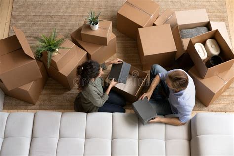 Top View Happy Couple Unpacking Boxes Moving Day Relocation Stock