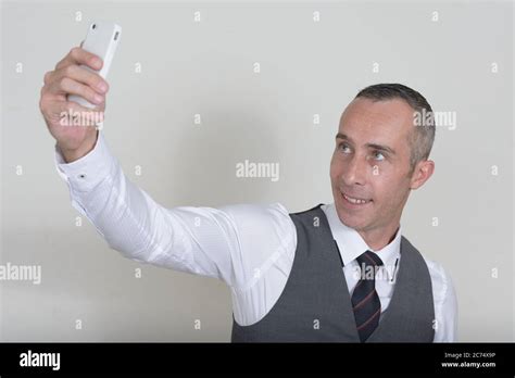 Portrait Of Happy Mature Handsome Businessman Against White Background