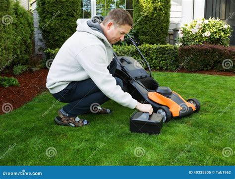Mature Man Putting Battery Into Electric Lawn Mower Stock Image Image