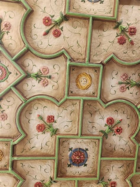 An Intricately Decorated Ceiling With Flowers And Leaves