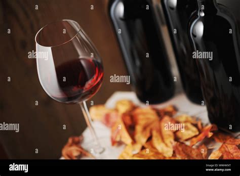 Glass Of Red Wine And A Bottle Of Red Wine On Background Shallow Dof