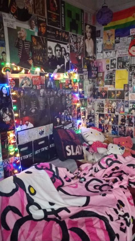 A Bedroom Decorated In Pink And Black With Posters On The Wall Bedding