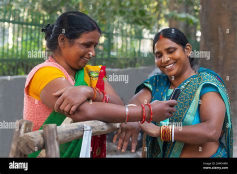 Two Maids Standing And Chatting On The Street Stock Photo Alamy