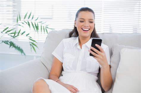 Premium Photo Happy Woman Looking At Her Phone And Laughing