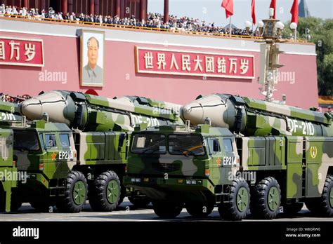 Military vehicles carrying DF-21D anti-ship ballistic missiles march ...