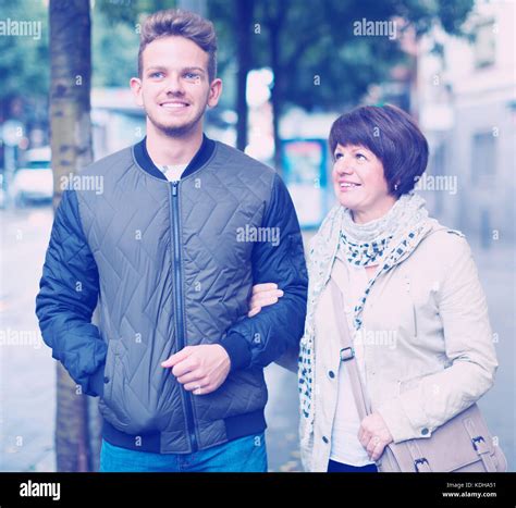 Mature Woman And Guy Taking Walk In Town At Summer Day Stock Photo Alamy