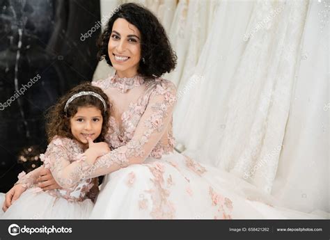 Brunette Middle Eastern Woman Wavy Hair Embracing Cute Girl Smiling