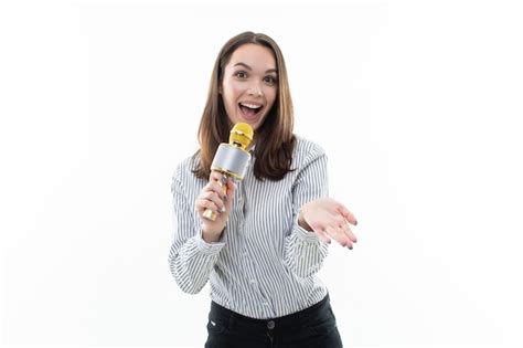 Premium Photo Smiling Brunette Sings Into A Microphone On A White Background