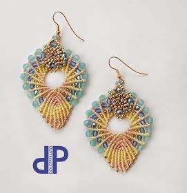 A Pair Of Earrings With Beading On Them