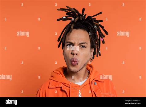 Portrait Of Pierced Multiracial Man With Dreadlocks Pouting Lips