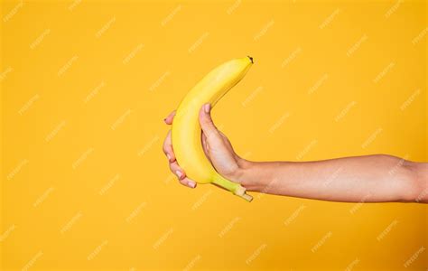 Premium Photo Female Hand Holding Banana Fruit Nutrition Concept