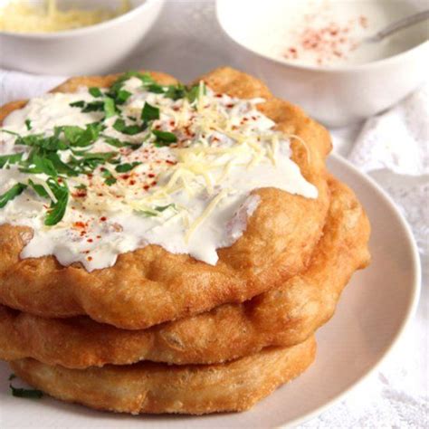 Crispy Hungarian Fried Bread Langos Topped With Garlic Sour Cream