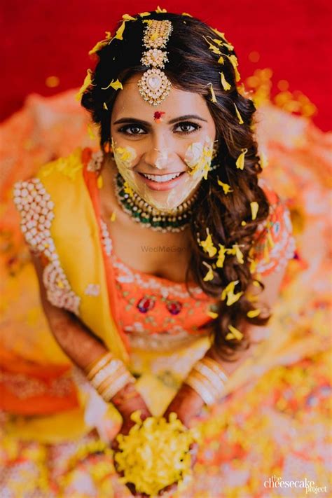 Photo Of Bride Wearing An Ombre Lehenga On Haldi Haldi Ceremony Outfit Bride Photos Poses