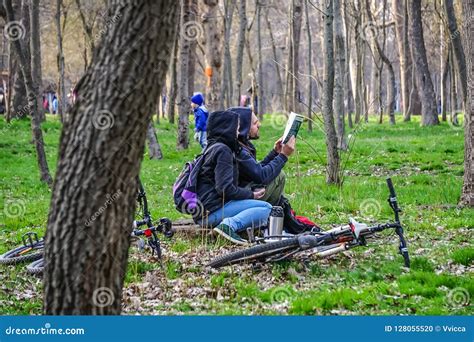 Man And Woman Resting In The City Park Reading A Book Editorial Image