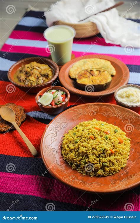 Achari Chicken Khichuri Combo With Egg Plant And Omelet Borhani Salad