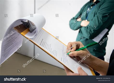 Inspector Writting On Clipboard Man Background Stock Photo 2101286530