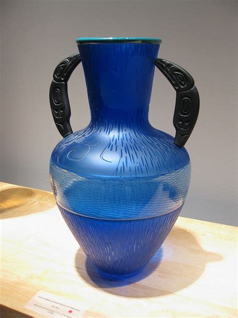 A Blue Vase Sitting On Top Of A Wooden Table