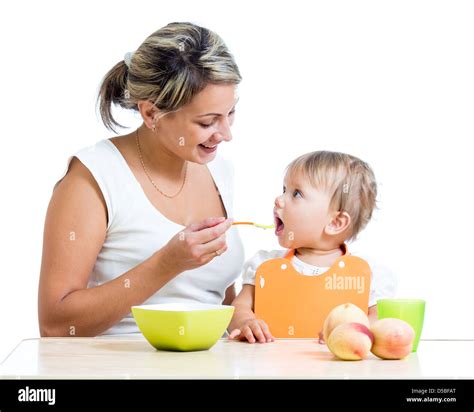 mother feeding her baby girl by spoon Stock Photo - Alamy