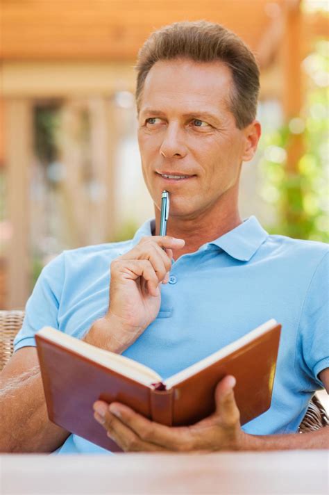 Waiting For Inspiration Thoughtful Mature Man Holding Note Pad And