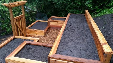 Terraced Cedar Raised Garden Bed With A Gate And Arbor Built Into The