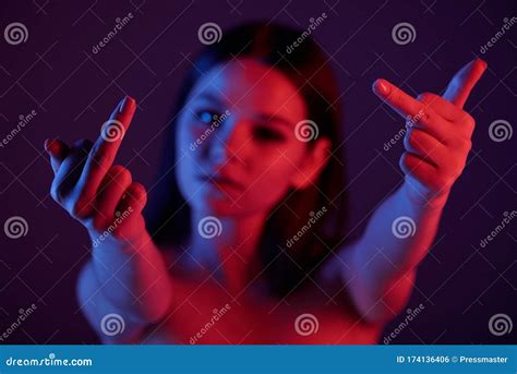 Young Rude Female Showing Indicent Gesture With Her Hands In Front Of