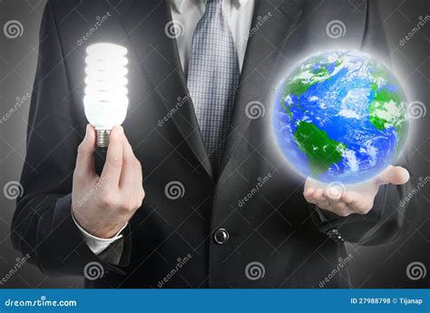 Businessman Holding A Light Bulb And Planet Earth Stock Photo Image