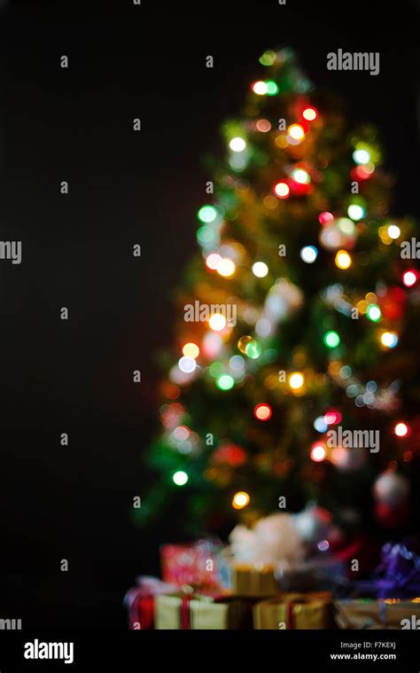 Colorful Christmas Background Of De Focused Lights With Decorated Tree