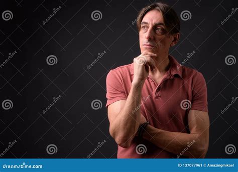 Mature Handsome Italian Man Thinking Against Gray Background Stock