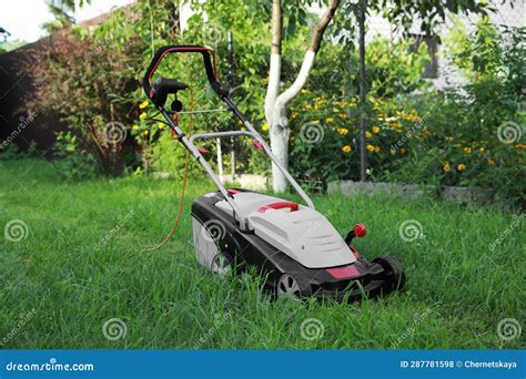 Lawn Mower on Green Grass in Garden Stock Photo - Image of backyard ...