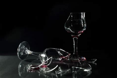 Broken Glass Cups With Reflection On A Glass Table Onr Black Background