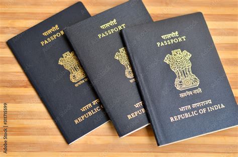 Multiple Indian Passports Kept Against Wooden Background On Display The National Emblem Of