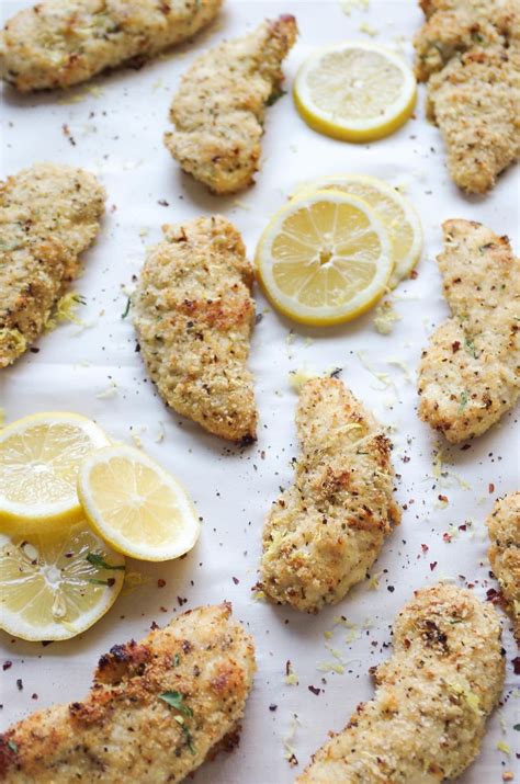 Chicken Tenderies With Lemons And Herbs On A Sheet Of Parchmented