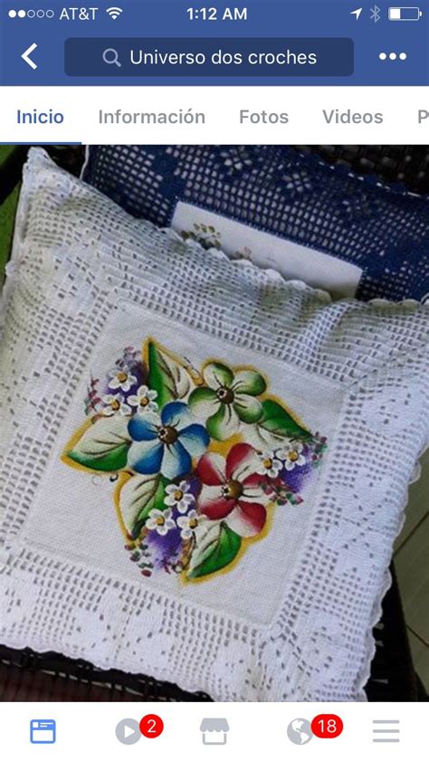 An Embroidered Pillow With Flowers On It