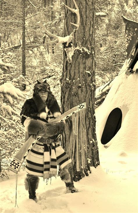 Mountain Man And Fur Trapper Twobears Keeping Warm In A Capote Mountain