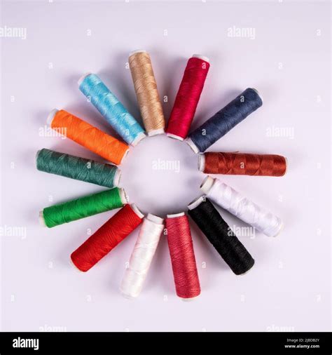 Spools Of Thread For Sewing In Different Colors On White Background