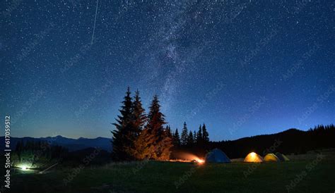 Night camping in mountains under starry sky. Tourist tents in campsite ...