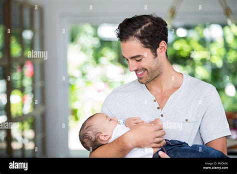 Smiling Father Carrying Baby Stock Photo Alamy