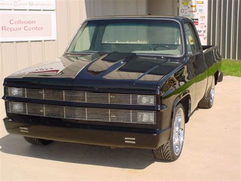 A Black Truck Parked In Front Of A Building