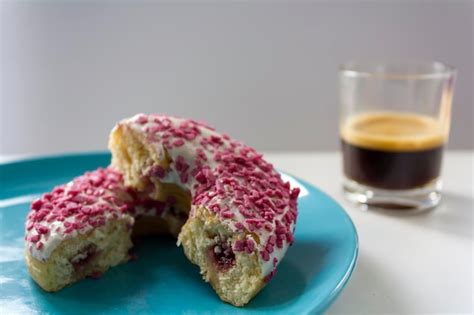 Premium Photo Delicious Glazed Donut With Strawberry Filling Cut In
