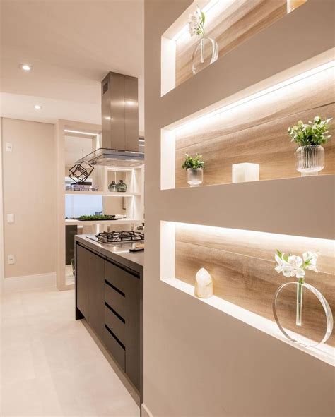 A Modern Kitchen With Wooden Shelves And White Counter Tops Along With