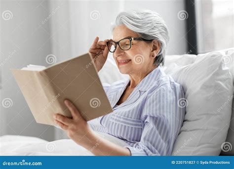 Old Woman In Glasses Reading Book In Bed At Home Stock Image Image Of