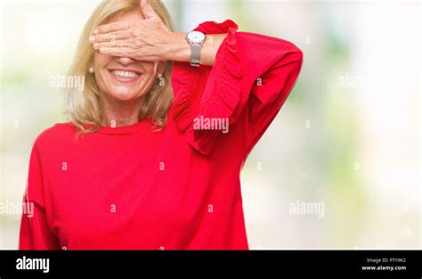 Middle Age Blonde Woman Over Isolated Background Smiling And Laughing With Hand On Face Covering