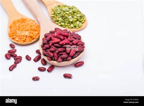 Red Kidney Beans Split Peas And Red Lentils In Wooden Spoon On White