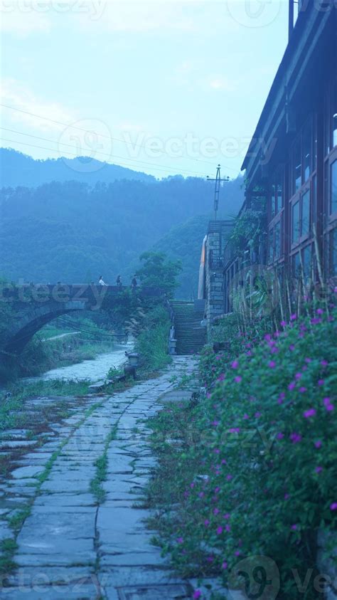 The beautiful Chinese countryside view with the old arched stone bridge above the river 8916419 ...