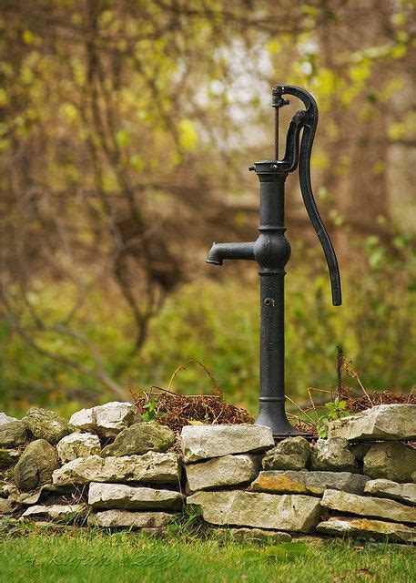 Pretty Water Pump On Stone Wall In Natural Garden