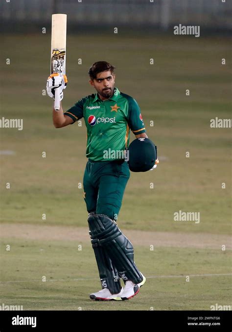 Pakistani Batsman Babar Azam Raises His Bat And Helmet To Celebrate His