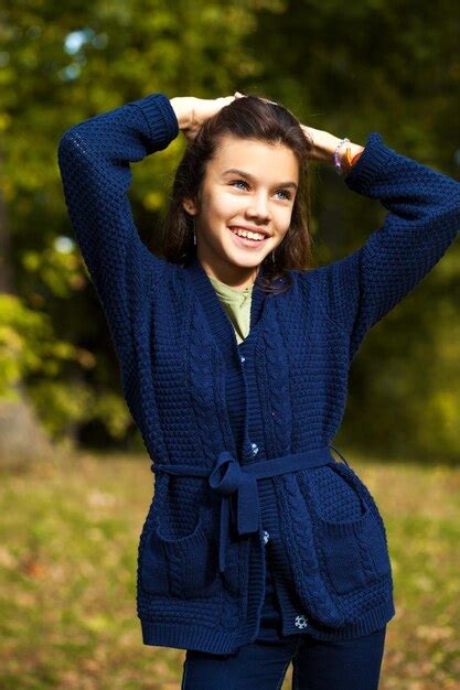 Premium Photo Happy Brunette Girl Posing In Autumn Park Background