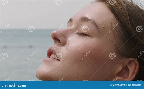 Beautiful Girl Enjoying Sunbath At Beach Close Up Face Of Young Tanned