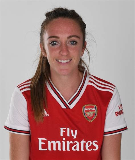 A Woman In A Red And White Soccer Uniform