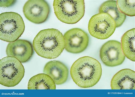 Pattern Of Kiwi Slices Levitating Above Green Background Stock Photo